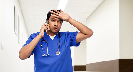 Image showing indian doctor or male nurse calling on smartphone