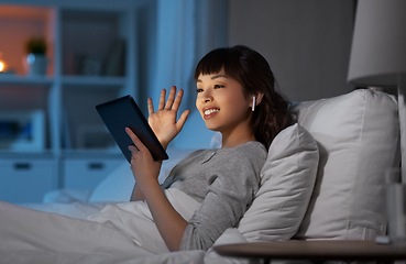 Image showing woman with tablet pc in bed has video call