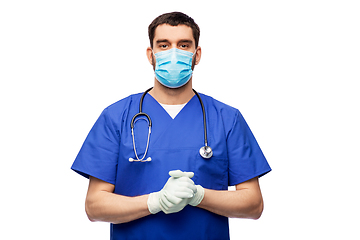 Image showing male doctor in blue uniform, mask and gloves