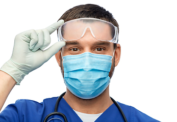 Image showing male doctor in goggles, mask and gloves