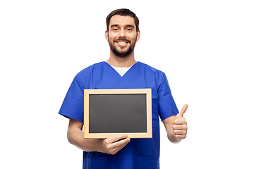 Image showing happy smiling male doctor or nurse with chalkboard