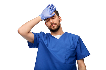 Image showing tired doctor or male nurse in blue uniform