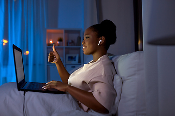 Image showing woman with laptop having video call at night