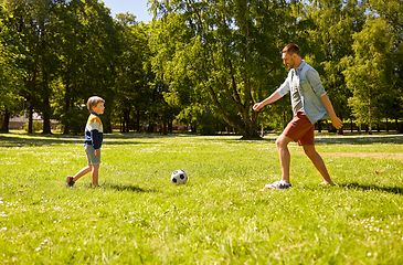 Image showing father with little son playing soccer at park