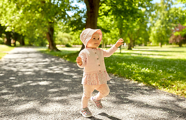 Image showing happy little baby girl walking in summer park