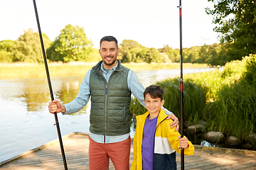 Image showing happy smiling father and son fishing on river