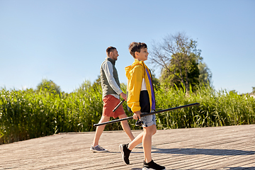 Image showing happy smiling father and son fishing on river