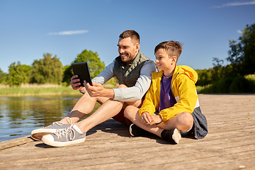 Image showing happy father and son with tablet pc on river berth