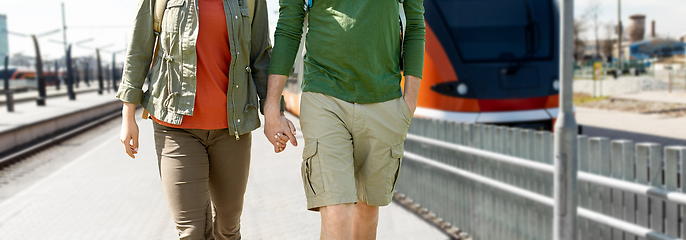 Image showing happy couple with backpacks traveling by train