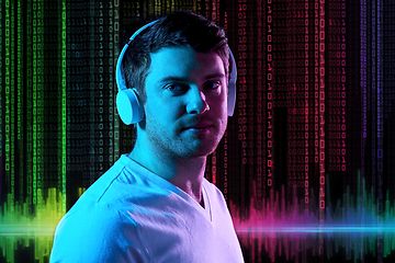 Image showing man in headphones over neon lights and binary code