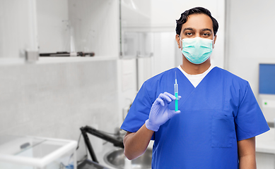 Image showing indian male doctor in mask with vaccine in syringe