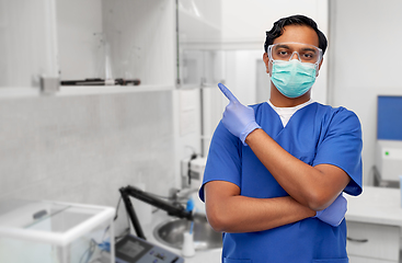 Image showing indian male doctor in mask showing something