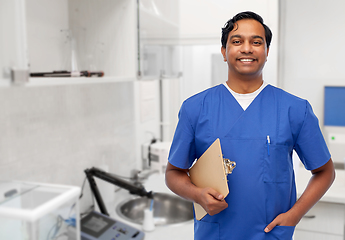 Image showing happy smiling indian male doctor with clipboard