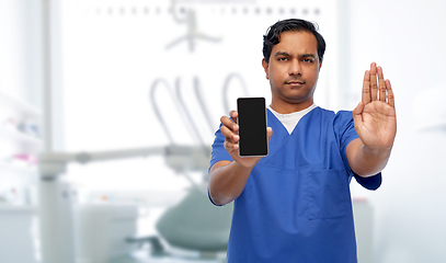 Image showing indian male doctor with phone showing stop gesture