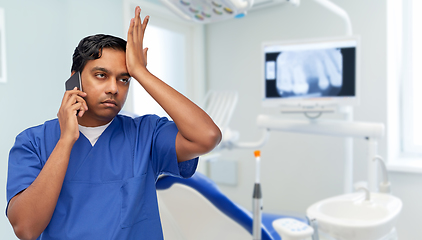 Image showing indian doctor or dentist calling on smartphone