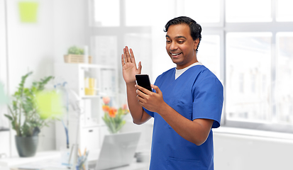 Image showing doctor or male nurse having video call on phone