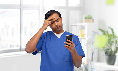 Image showing indian doctor or male nurse using smartphone