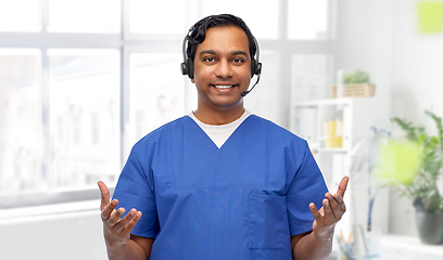 Image showing smiling indian doctor or male nurse with headset