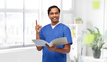 Image showing indian male doctor with folder pointing finger up