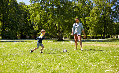 Image showing father with little son playing soccer at park