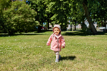 Image showing happy little baby girl walking in summer park