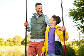 Image showing happy smiling father and son fishing on river