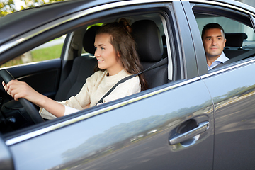 Image showing female driver driving car with male passenger