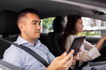 Image showing woman and driving school instructor in car