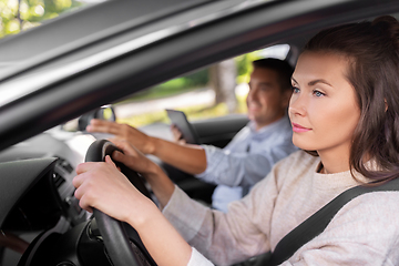 Image showing car driving school instructor teaching woman