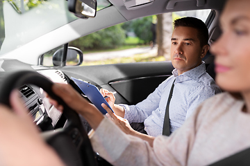 Image showing car driving school instructor and young driver