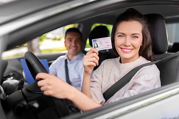 Image showing car driving instructor and driver with license