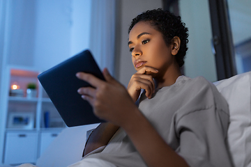 Image showing woman with tablet pc in bed at home at night