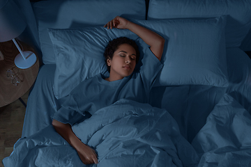 Image showing african woman sleeping in bed at home at night