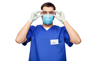Image showing male doctor in goggles, mask and gloves
