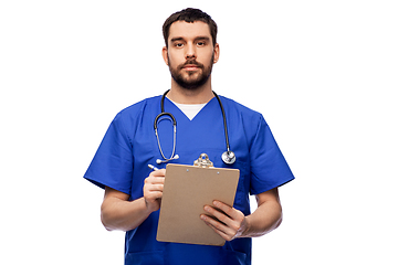 Image showing male doctor writing medical report on clipboard