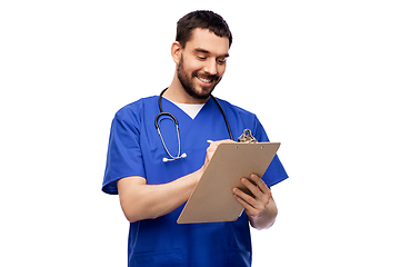 Image showing male doctor writing medical report on clipboard