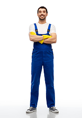 Image showing happy male worker or cleaner in overal and gloves