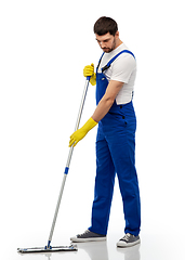 Image showing male cleaner in overal cleaning floor with mop