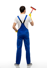 Image showing male cleaner in overal with window cleaning mop
