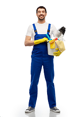 Image showing male cleaner in overal with cleaning supplies