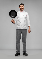 Image showing happy smiling male chef in jacket with frying pan