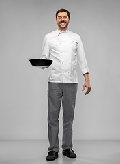 Image showing happy smiling male chef in jacket with frying pan