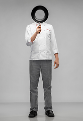 Image showing male chef hiding his face over frying pan