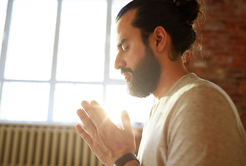 Image showing close up of man meditating at yoga studio