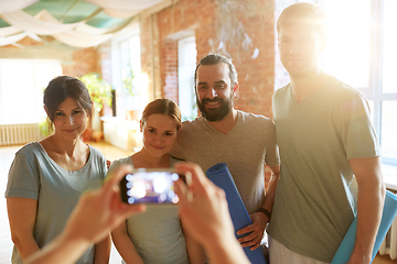 Image showing happy people at yoga studio or gym photographing