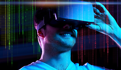 Image showing man in vr glasses over neon lights and binary code