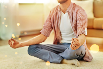 Image showing close up of man meditating at home