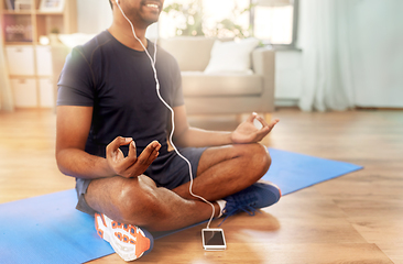 Image showing indian man meditating in lotus pose at home