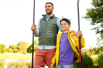 Image showing happy smiling father and son fishing on river