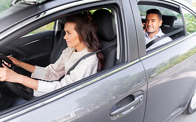 Image showing female driver driving car with male passenger